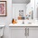 bathroom with a large mirror and ample lighting