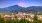 View of a town within trees and mountains in the background